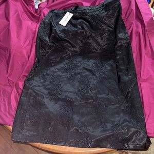 Black skirt with design. never been worn. has slit on side as well.